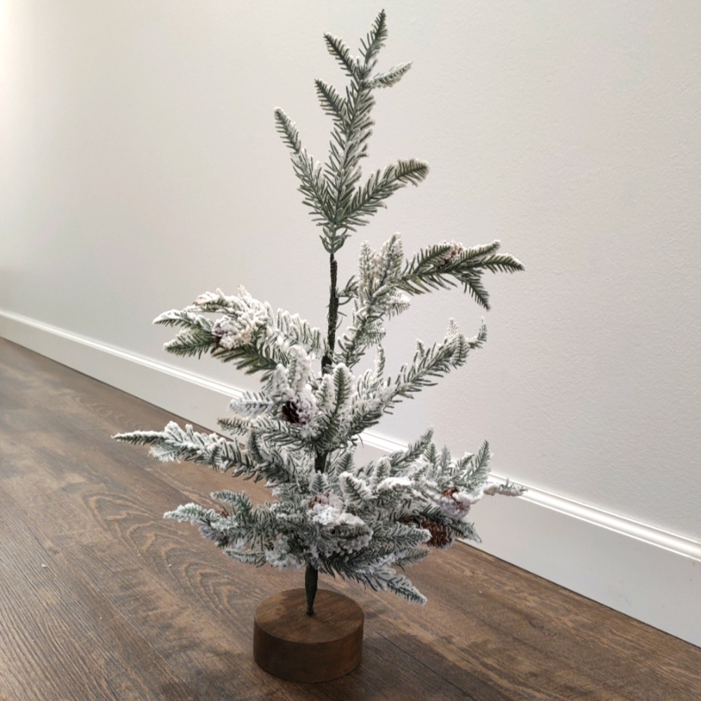Winter pine tree decor - pine branches, pine cones, and a dark wood painted base